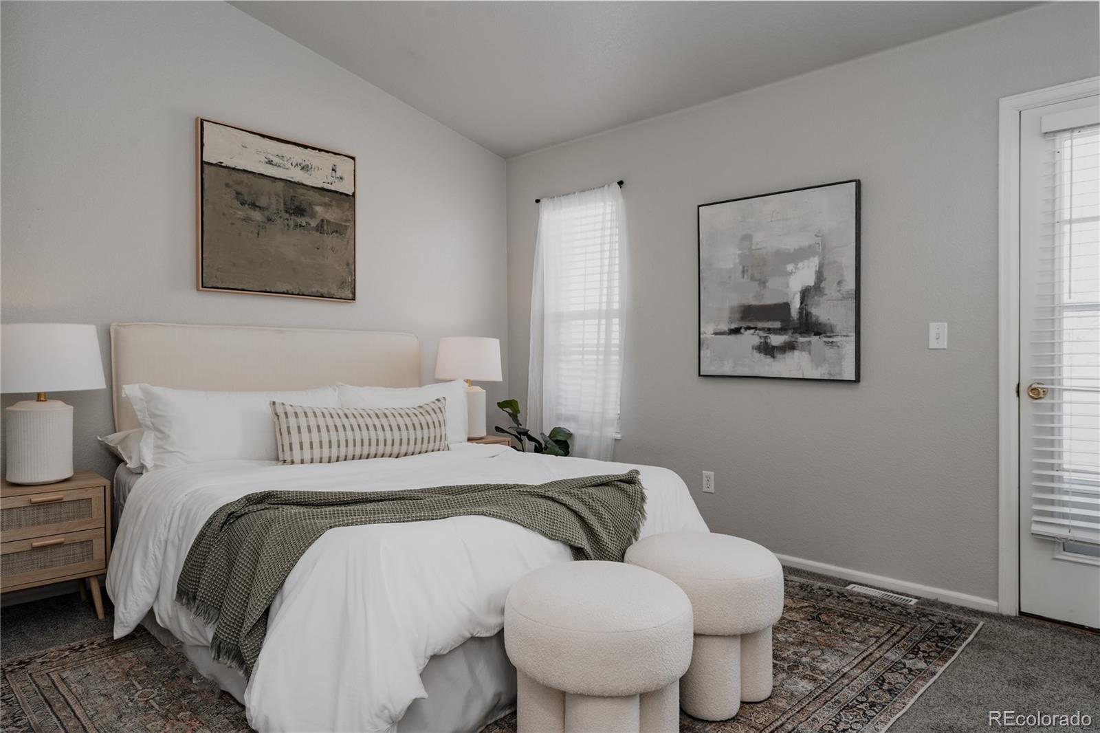 5081 Garrison Street, Unit 9 Wheat Ridge, CO 80033 - Photo 17 of 31 a bedroom with a bed and a painting on the wall