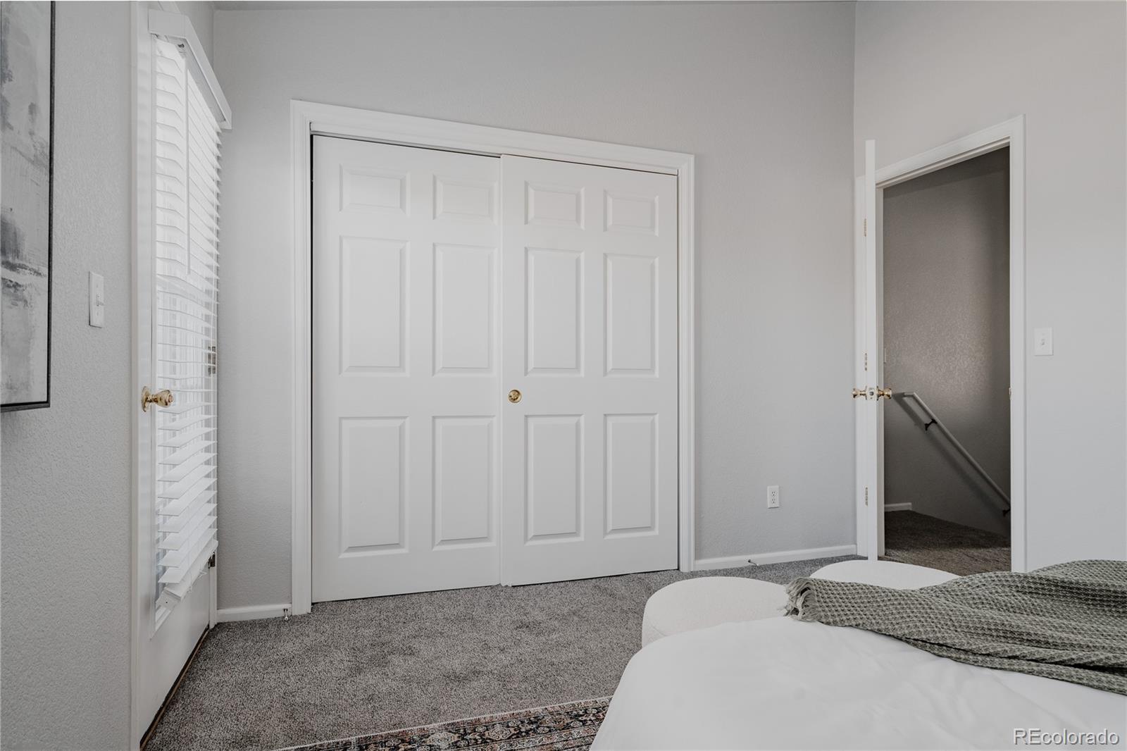5081 Garrison Street, Unit 9 Wheat Ridge, CO 80033 - Photo 21 of 31 a bedroom with a bed and a closet