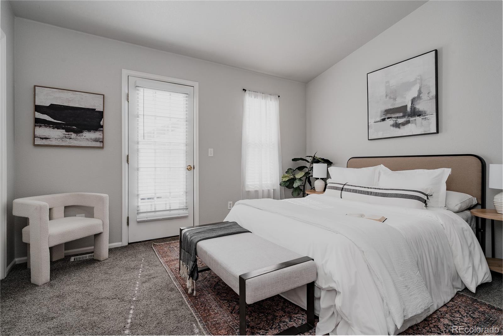 5081 Garrison Street, Unit 9 Wheat Ridge, CO 80033 - Photo 22 of 31 a bedroom with a bed and a couch