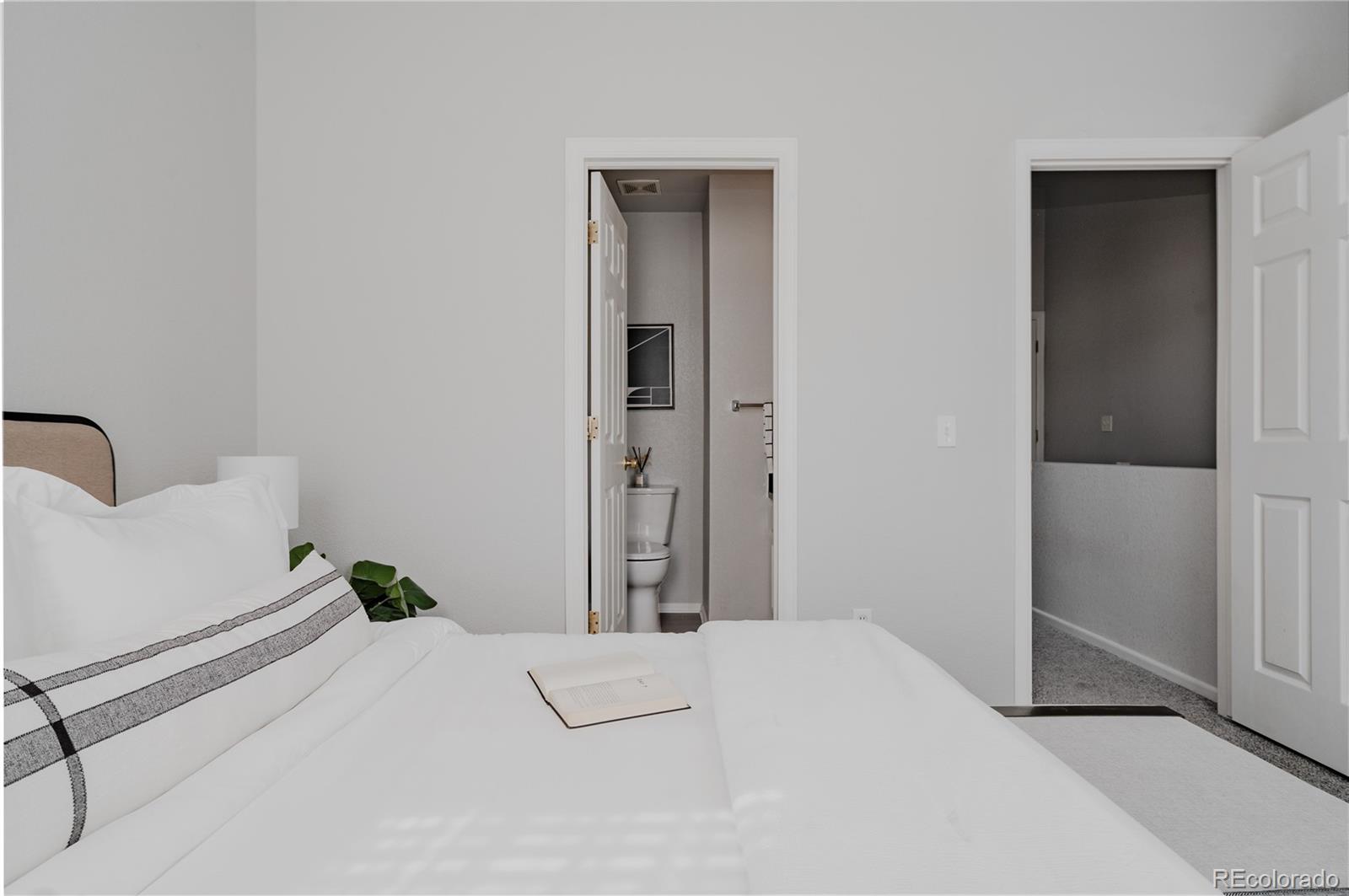 5081 Garrison Street, Unit 9 Wheat Ridge, CO 80033 - Photo 25 of 31 a bedroom with a bed and a lamp