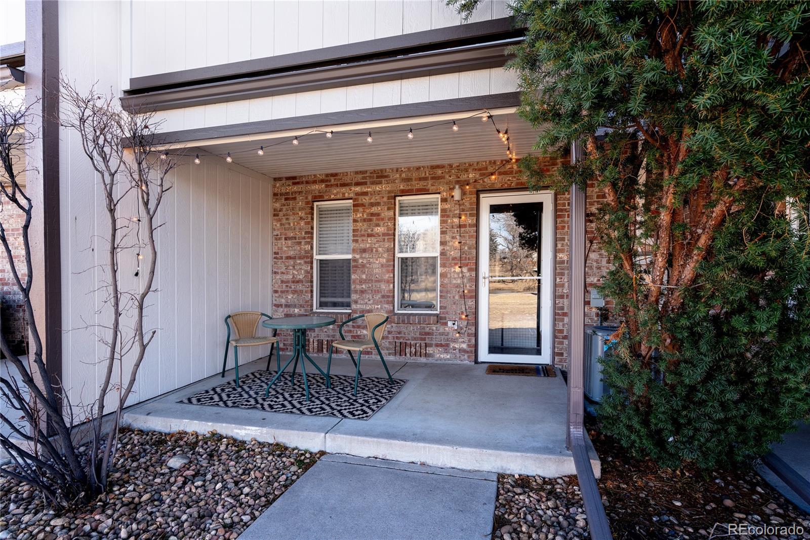 5081 Garrison Street, Unit 9 Wheat Ridge, CO 80033 - Photo 30 of 31 a view of a porch with chairs and potted plants