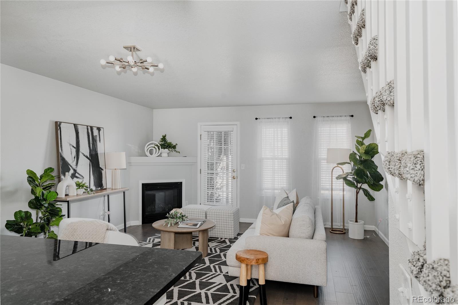 5081 Garrison Street, Unit 9 Wheat Ridge, CO 80033 - Photo 8 of 31 a living room with furniture and a fireplace