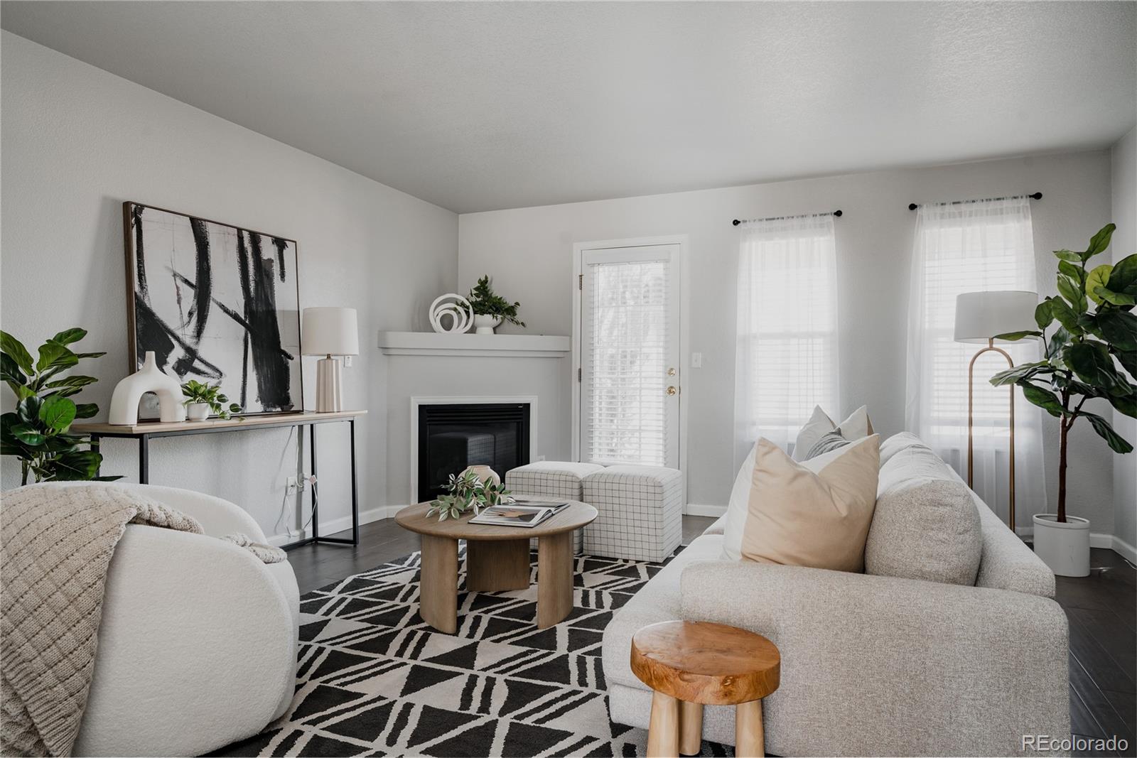 5081 Garrison Street, Unit 9 Wheat Ridge, CO 80033 - Photo 9 of 31 a living room with furniture a fireplace and a potted plant