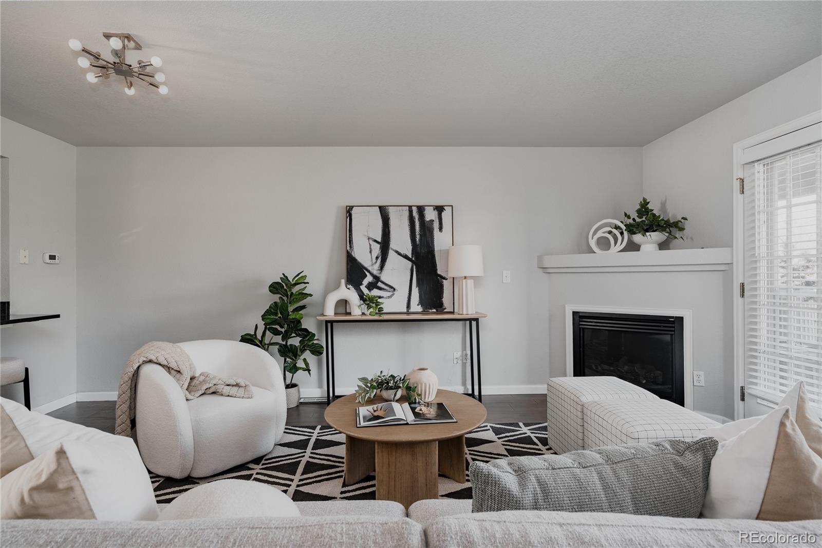 5081 Garrison Street, Unit 9 Wheat Ridge, CO 80033 - Photo 10 of 31 a living room with furniture and a fireplace
