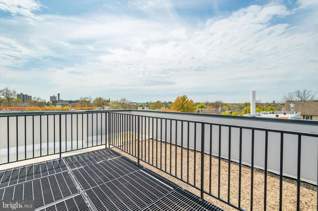 a balcony with wooden floor and city view