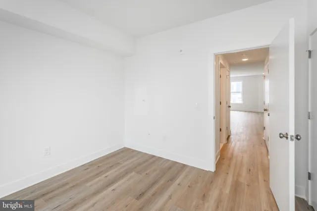 a view of a room with wooden floor