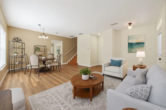a living room with furniture and a wooden floor