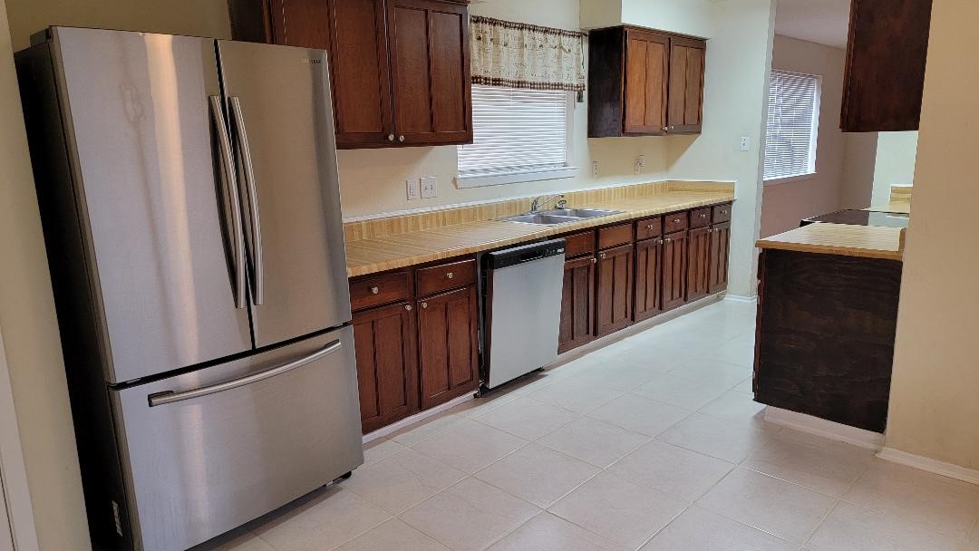 3319 Boxelder Drive Houston, TX 77082 - Photo 4 of 9 a kitchen with stainless steel appliances a refrigerator and a sink