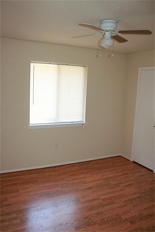 3319 Boxelder Drive Houston, TX 77082 - Photo 7 of 9 a view of a room with wooden floor and windows