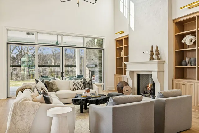 a large kitchen with kitchen island a stove a sink a dining table and chairs with wooden floor