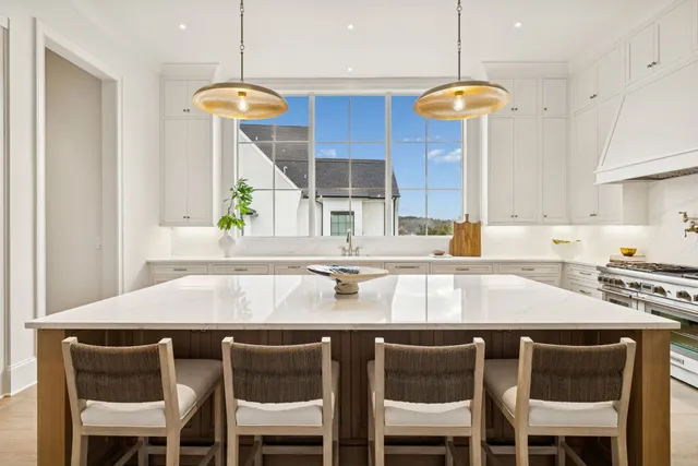 a living room with furniture a fireplace and a floor to ceiling window