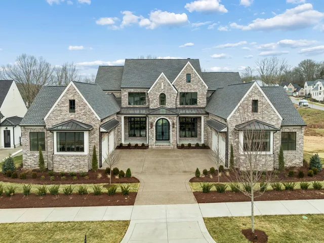 a living room with furniture fireplace and a large window