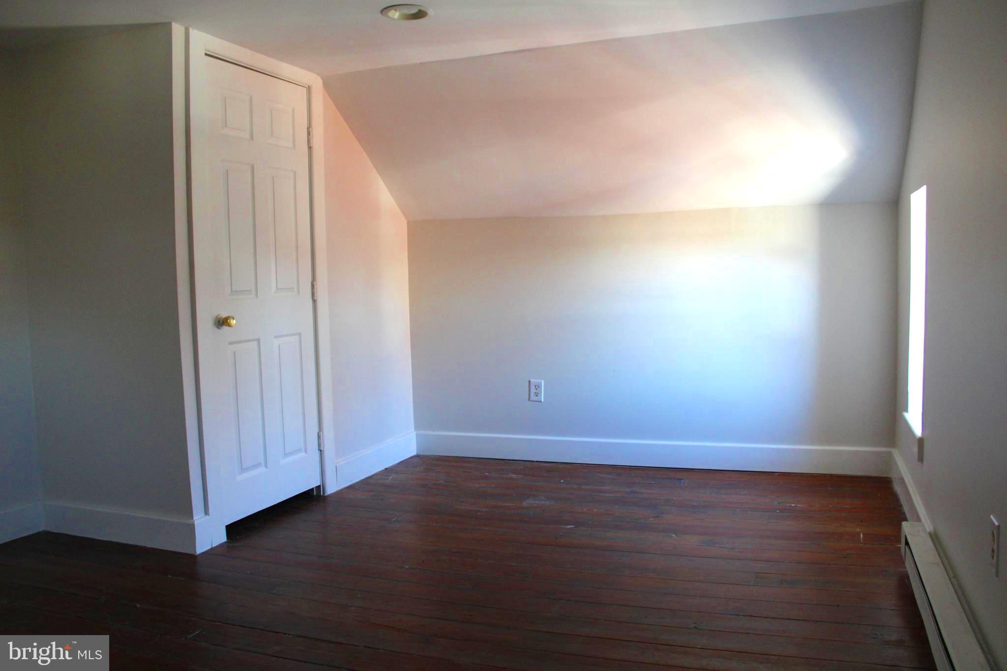 19332 Longmeadow Road Hagerstown, MD 21742 - Photo 17 of 21 an empty room with wooden floor and windows