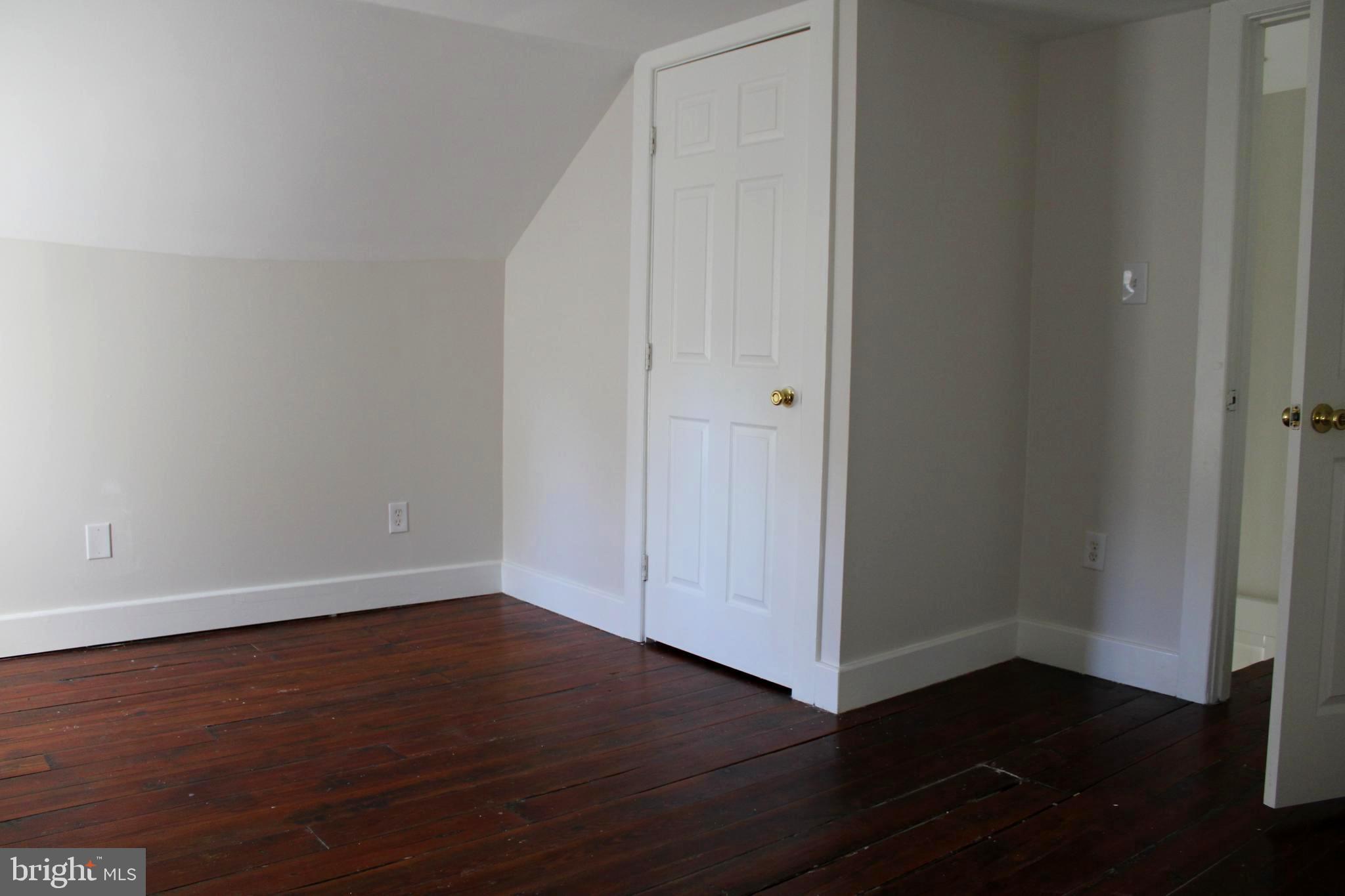 19332 Longmeadow Road Hagerstown, MD 21742 - Photo 20 of 21 an empty room with wooden floor