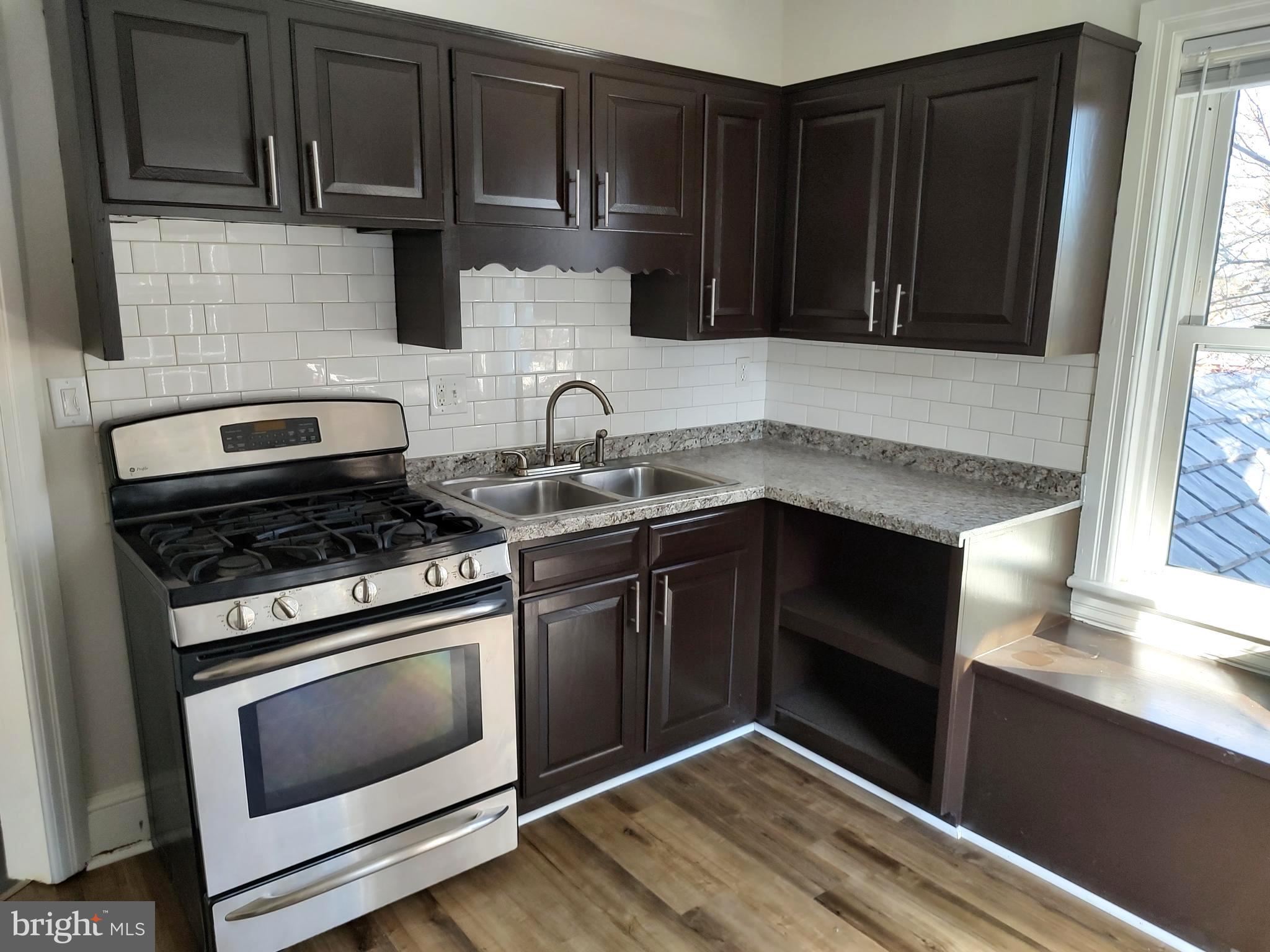 19332 Longmeadow Road Hagerstown, MD 21742 - Photo 4 of 21 a kitchen with granite countertop a stove and a sink
