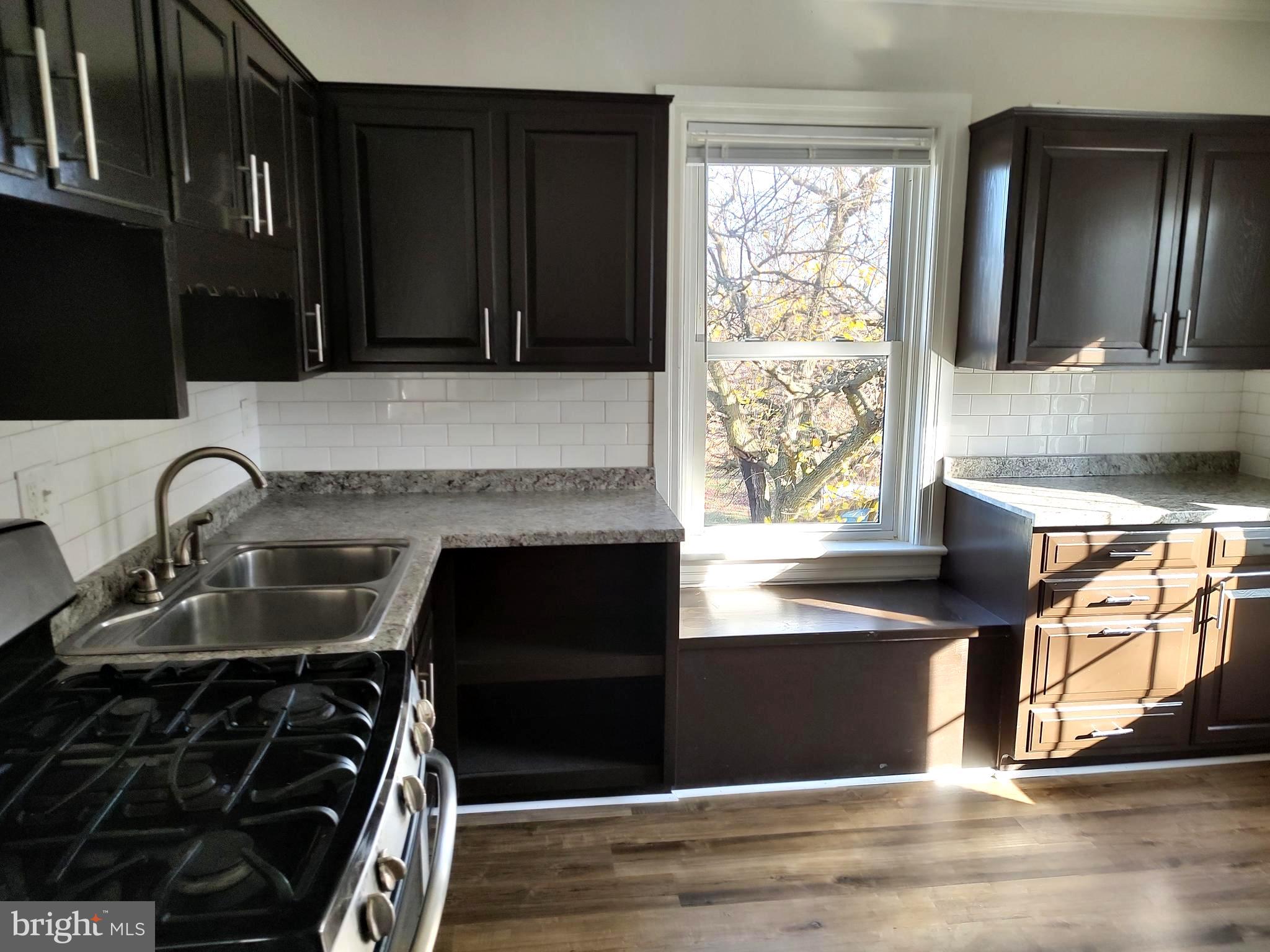 19332 Longmeadow Road Hagerstown, MD 21742 - Photo 5 of 21 a kitchen with granite countertop a stove and a sink