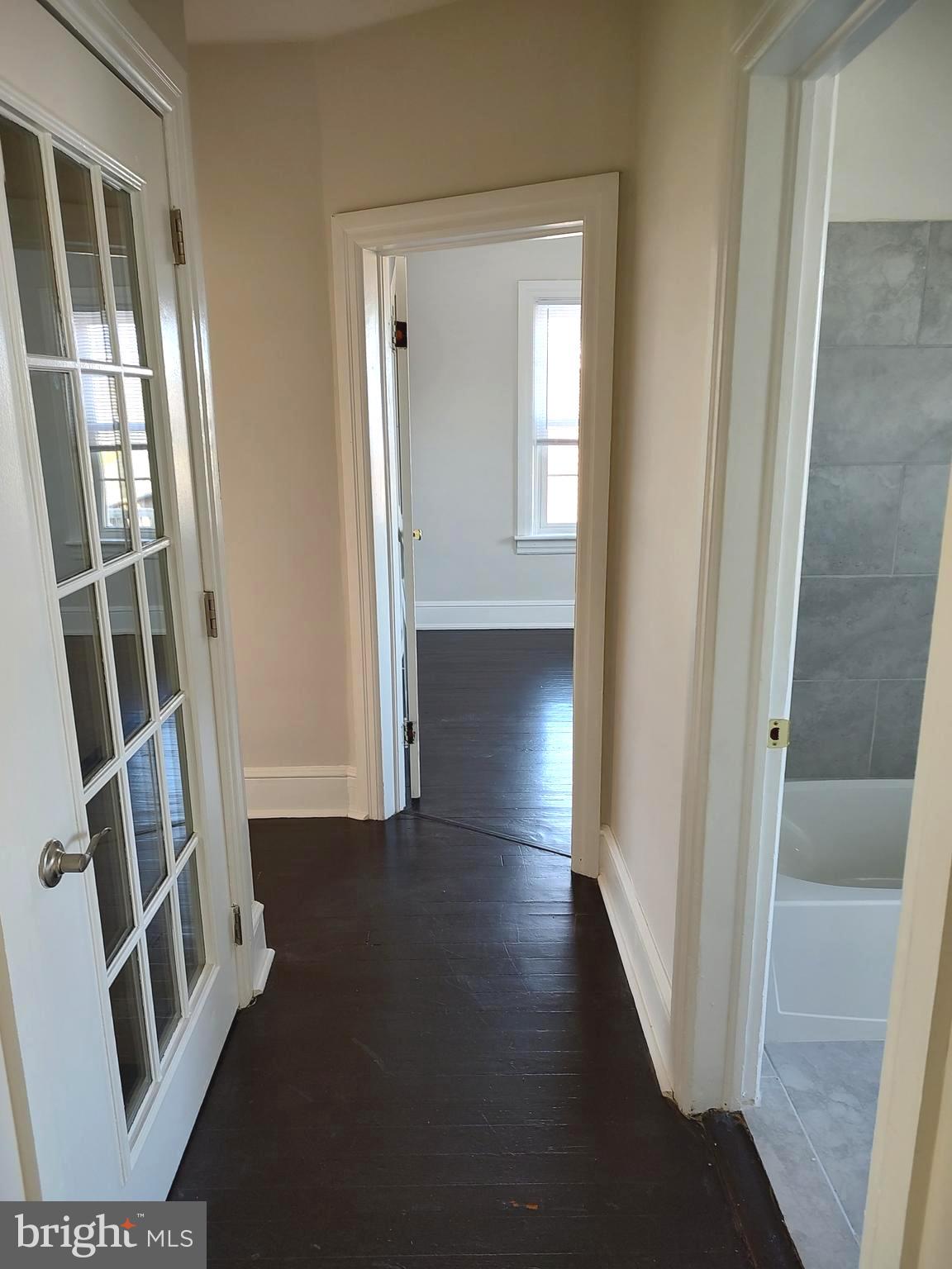 19332 Longmeadow Road Hagerstown, MD 21742 - Photo 9 of 21 a view of a hallway with wooden floor and stairs