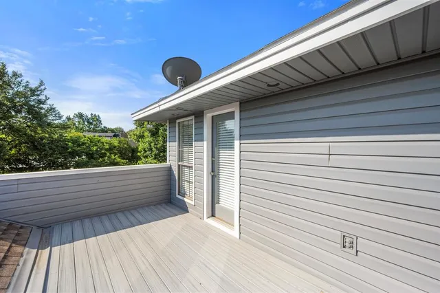a view of a balcony with a floor to ceiling window and wooden floor