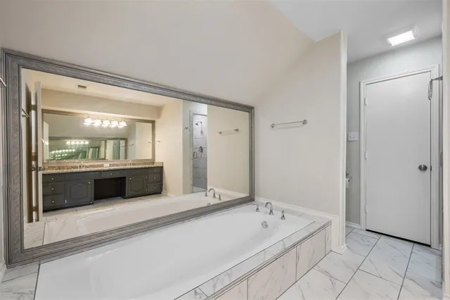 a bathroom with a bathtub and a sink