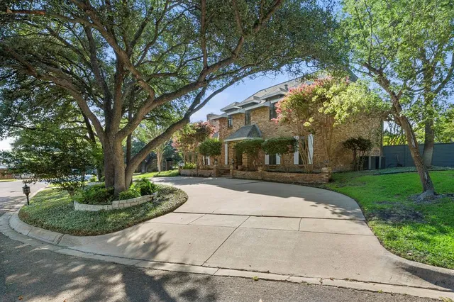 a view of a white house with a yard and plants