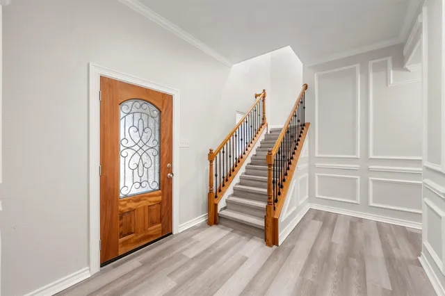 a view of front door with hallway and stairs