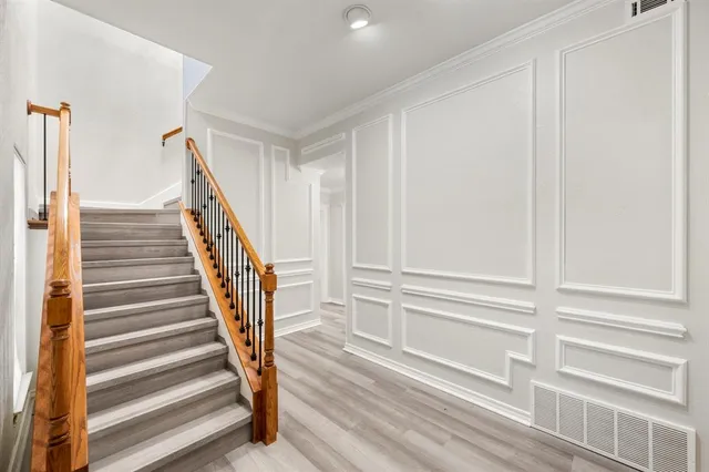 a view of entryway with wooden floor and stairs