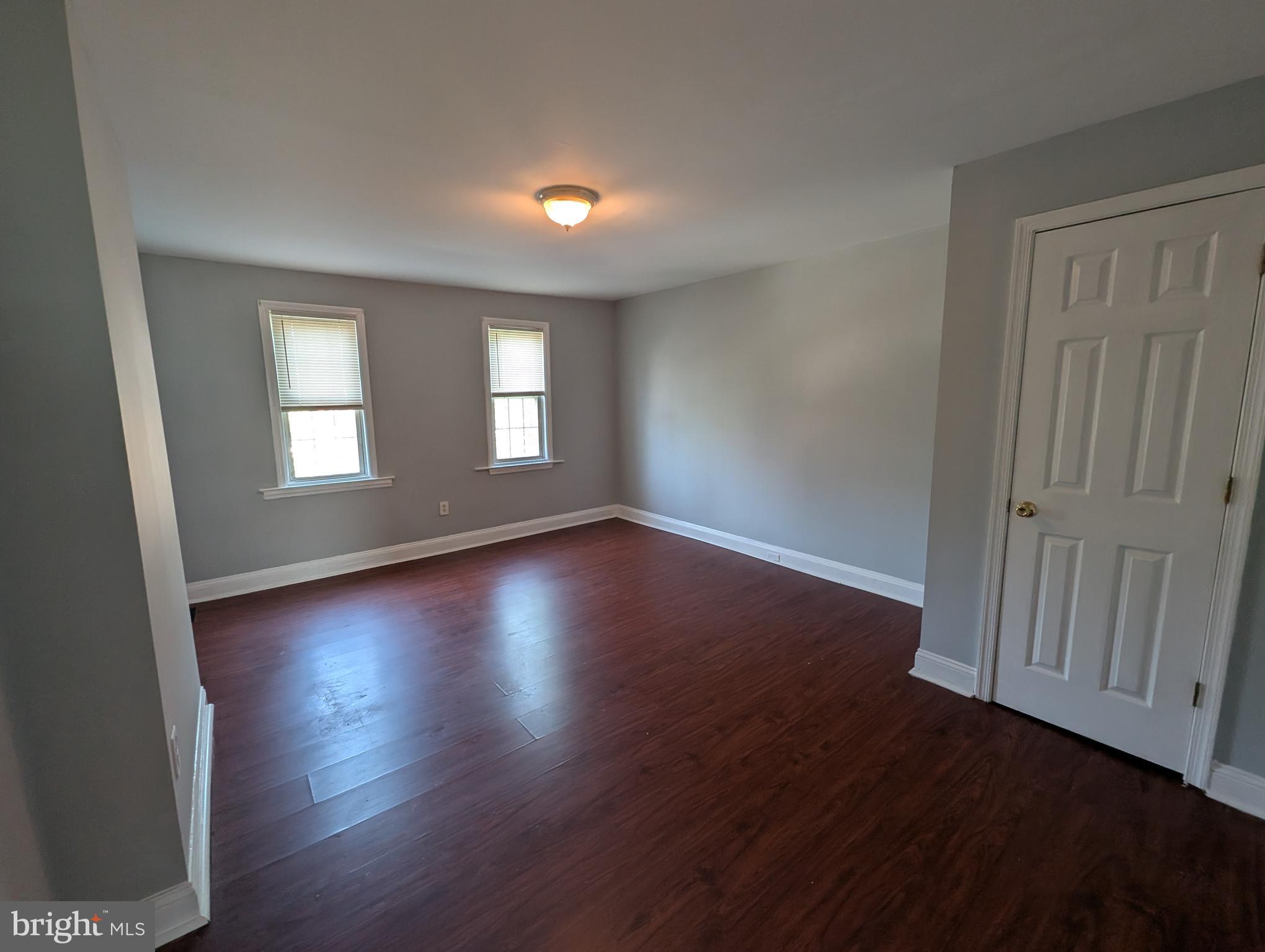 1835 North Bond Street Baltimore, MD 21213 - Photo 14 of 25 an empty room with wooden floor and windows
