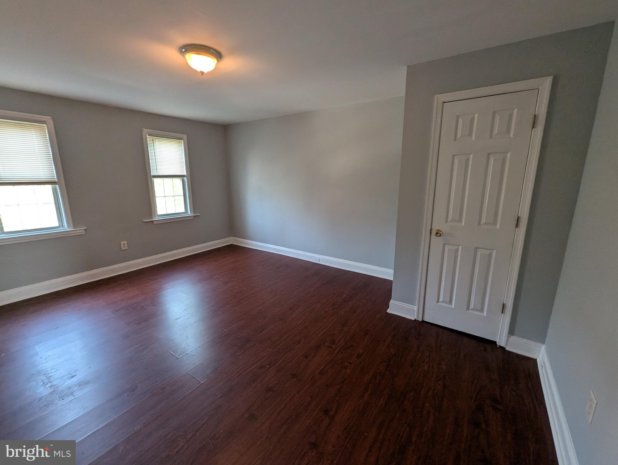 1835 North Bond Street Baltimore, MD 21213 - Photo 15 of 25 an empty room with wooden floor and windows