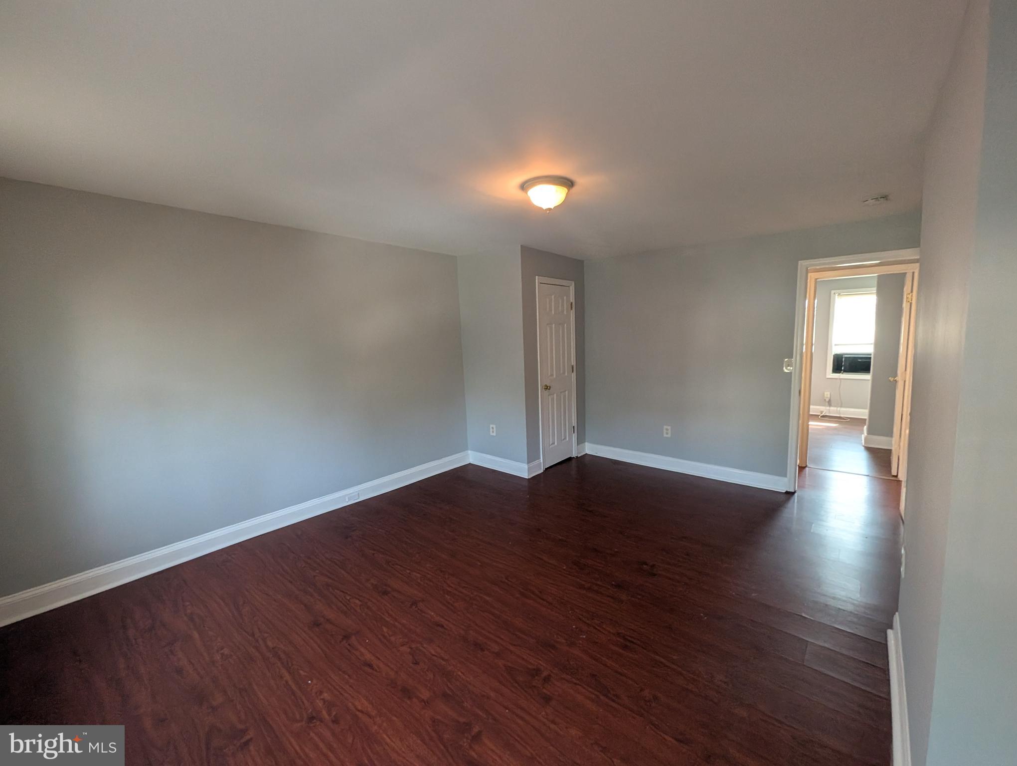 1835 North Bond Street Baltimore, MD 21213 - Photo 16 of 25 a view of an empty room with wooden floor and a window