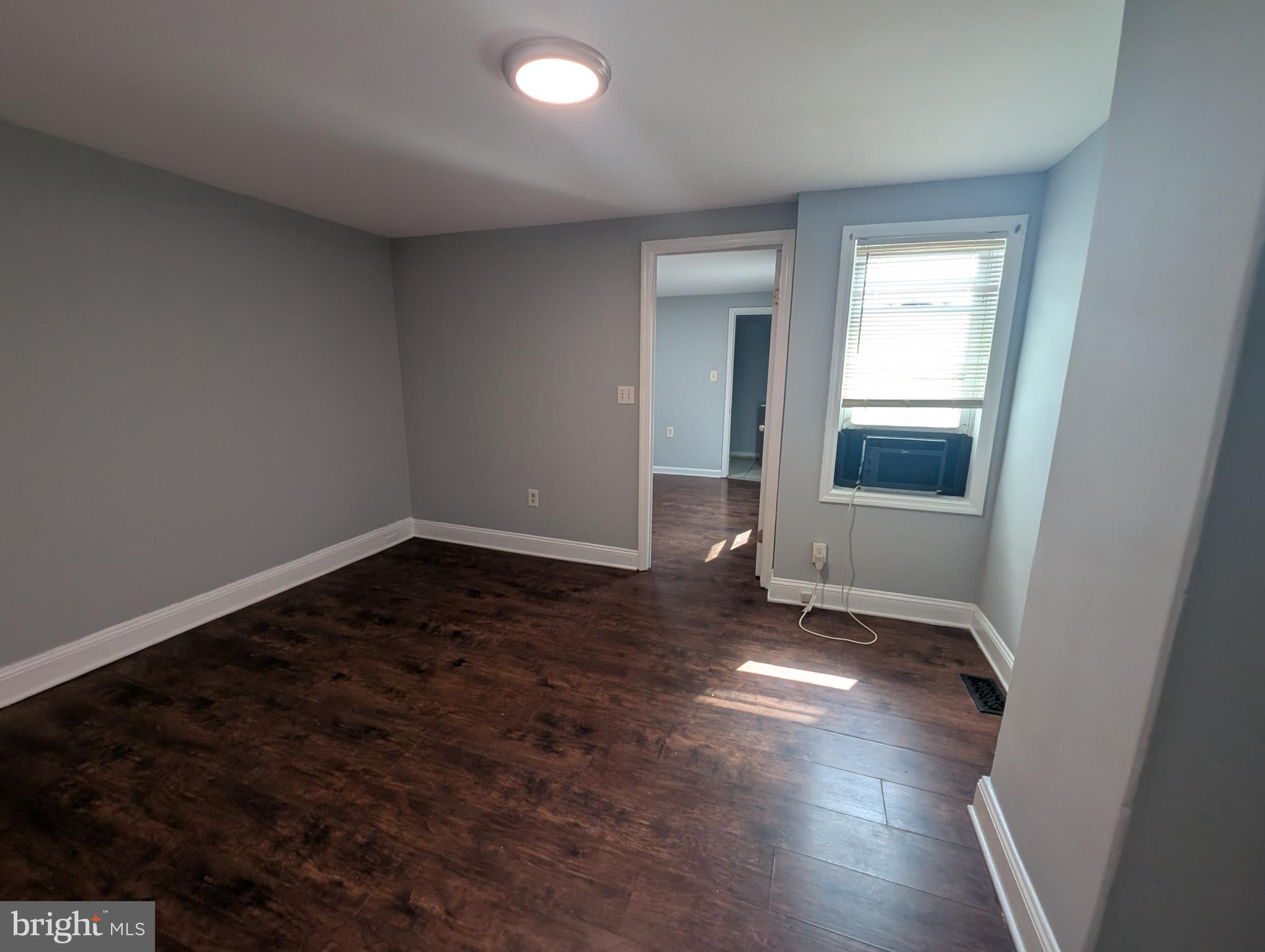 1835 North Bond Street Baltimore, MD 21213 - Photo 19 of 25 an empty room with wooden floor and windows