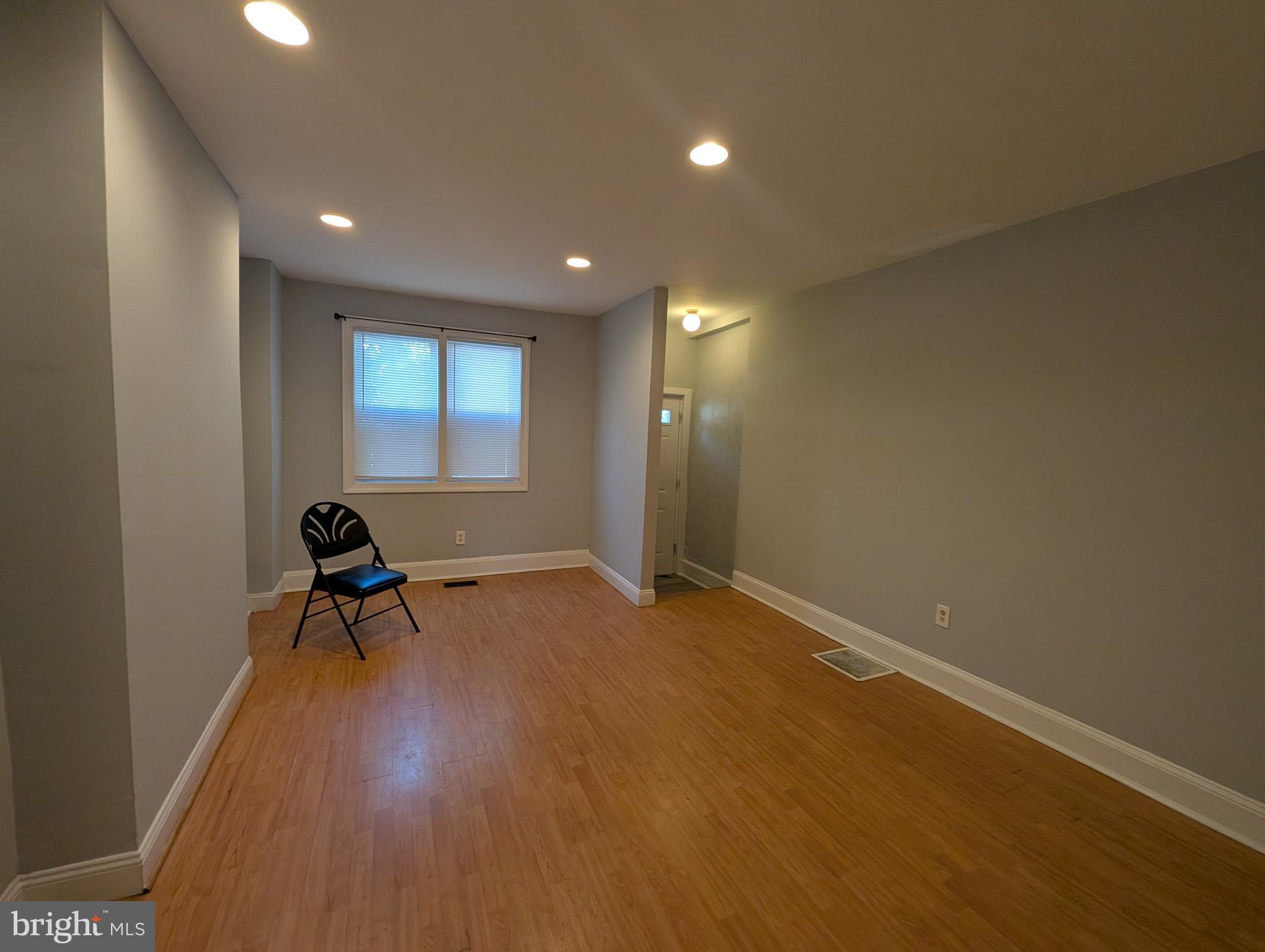 1835 North Bond Street Baltimore, MD 21213 - Photo 3 of 25 a view of a room with windows and wooden floor