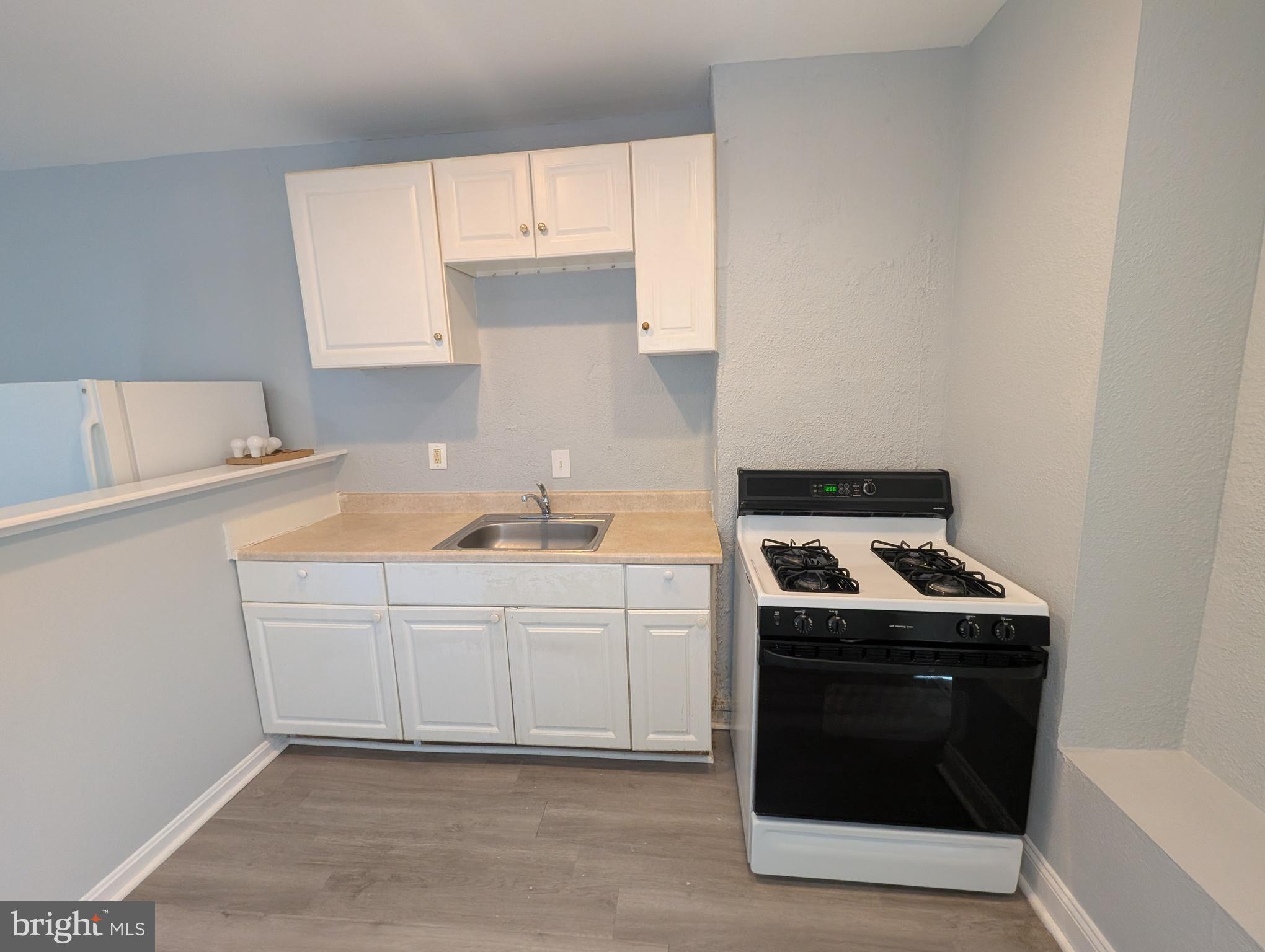 1835 North Bond Street Baltimore, MD 21213 - Photo 9 of 25 a kitchen with a stove and a sink