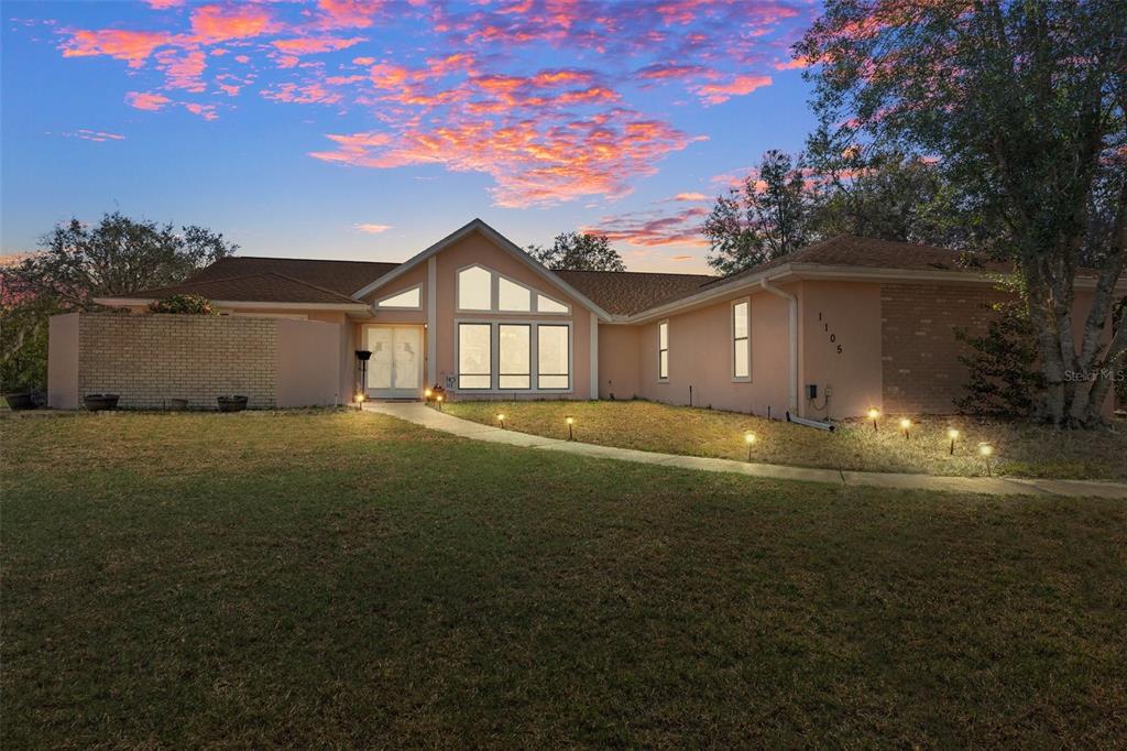 a view of house with yard
