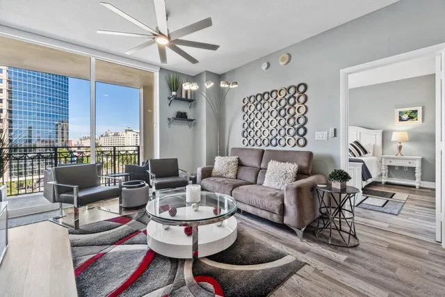 a living room with furniture and wooden floor