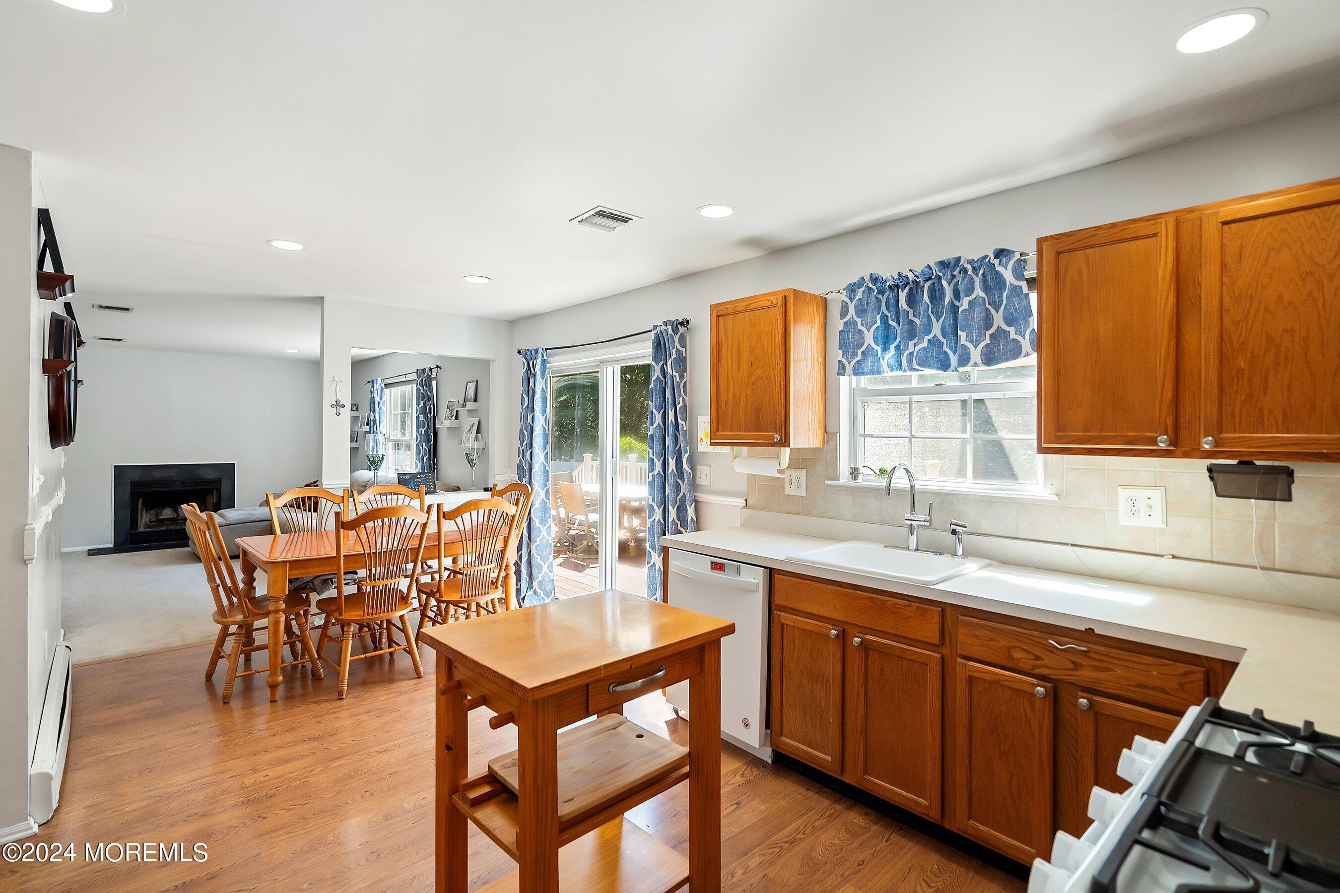 17 Glacier Drive Howell, NJ 07731 - Photo 13 of 43 a dining room with a wooden table and chairs