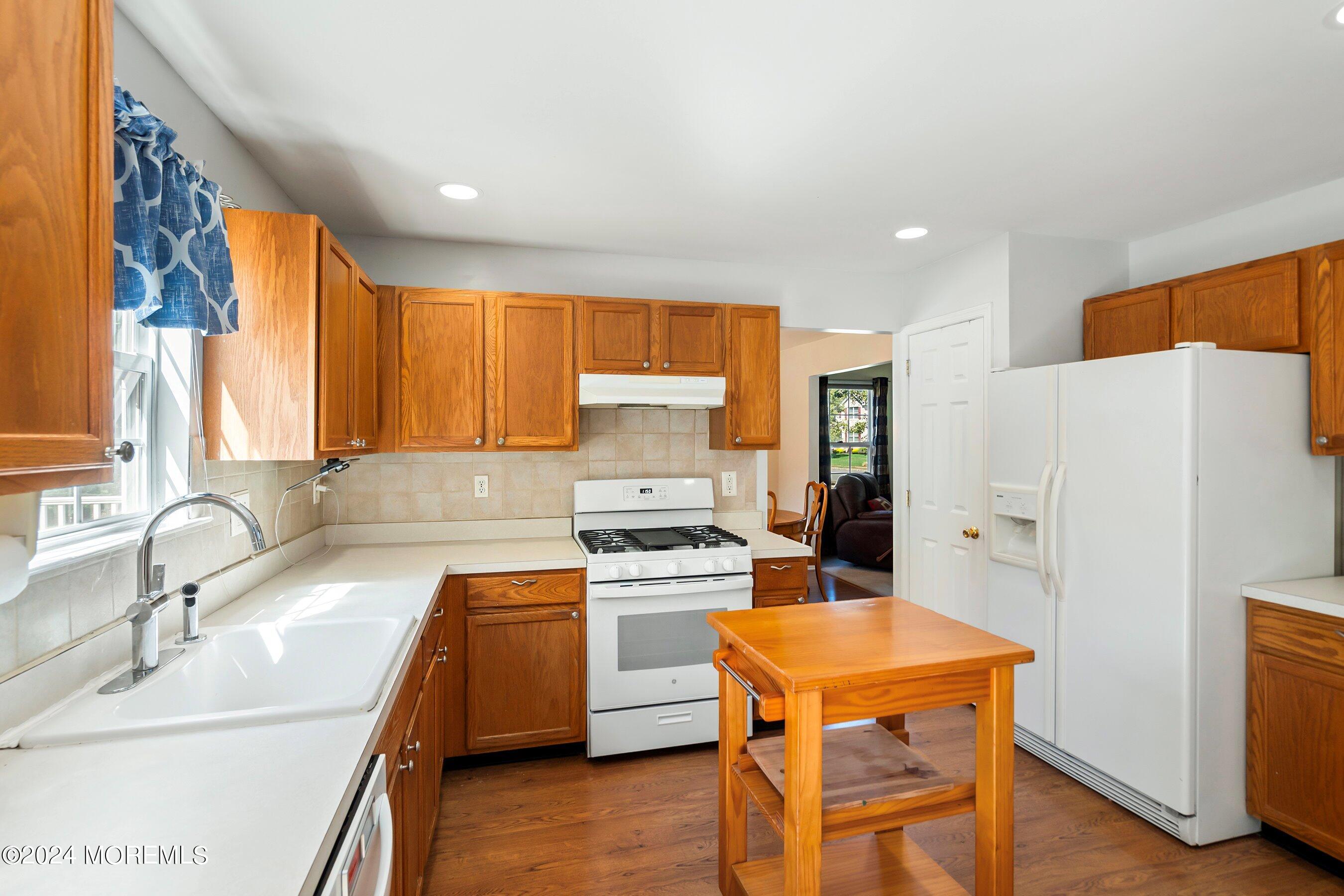 17 Glacier Drive Howell, NJ 07731 - Photo 15 of 43 a kitchen with stainless steel appliances granite countertop a sink stove and refrigerator