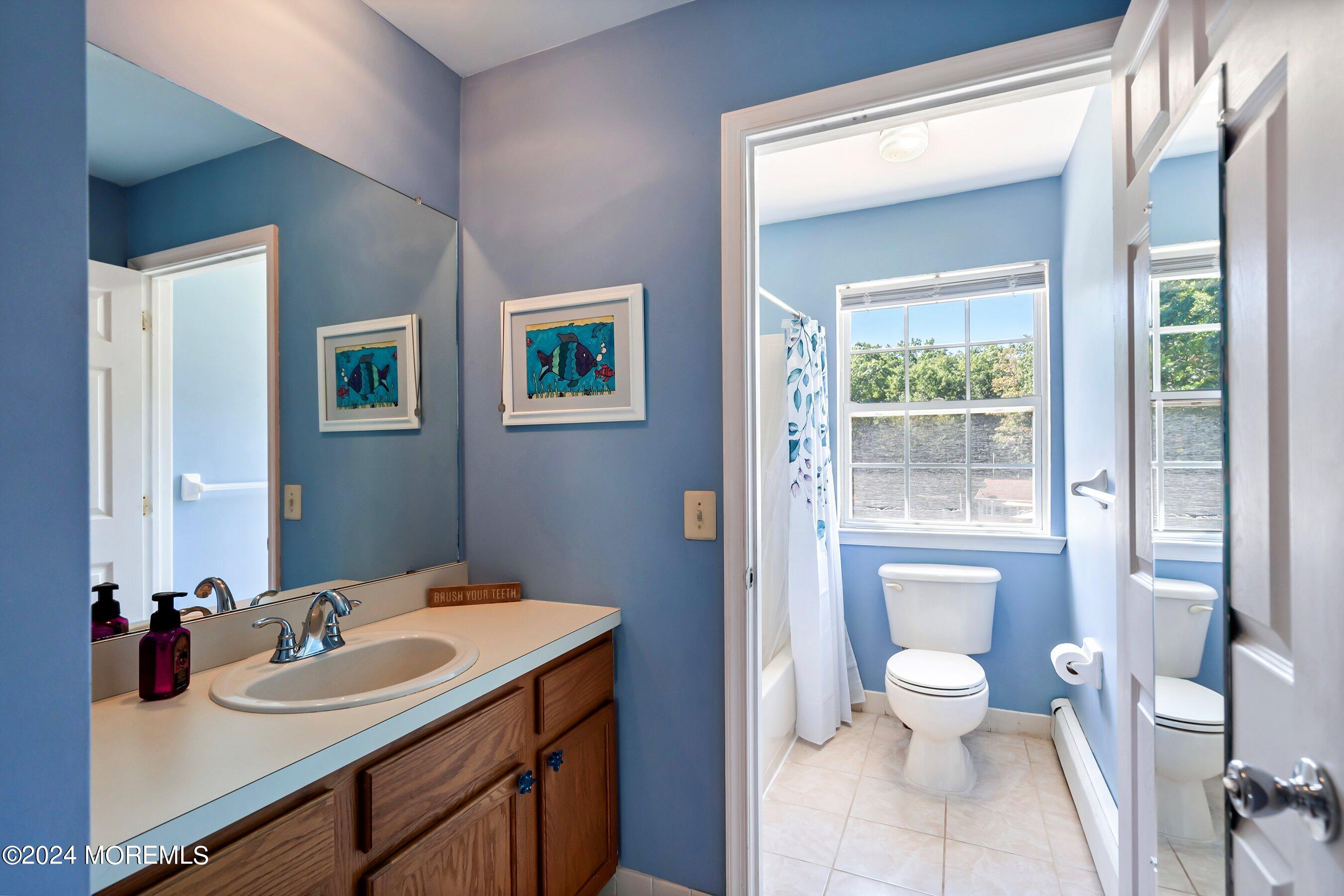 17 Glacier Drive Howell, NJ 07731 - Photo 19 of 43 a bathroom with a sink a toilet and a large mirror