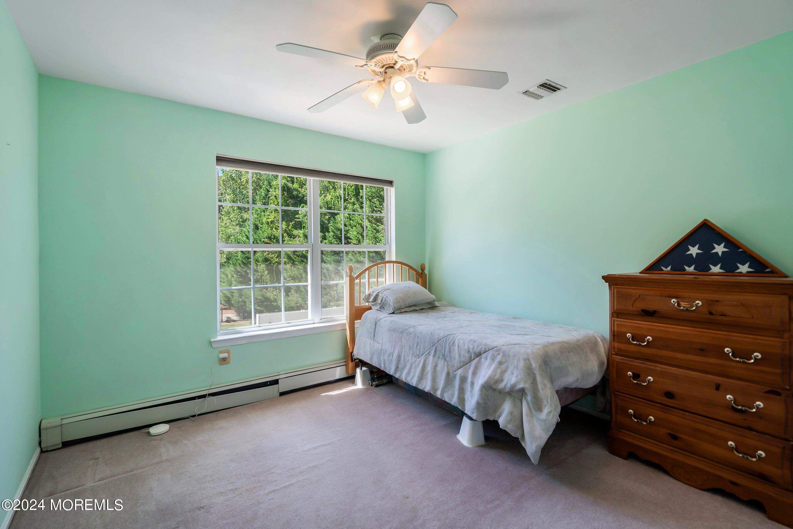 17 Glacier Drive Howell, NJ 07731 - Photo 20 of 43 a bedroom with a bed and a window