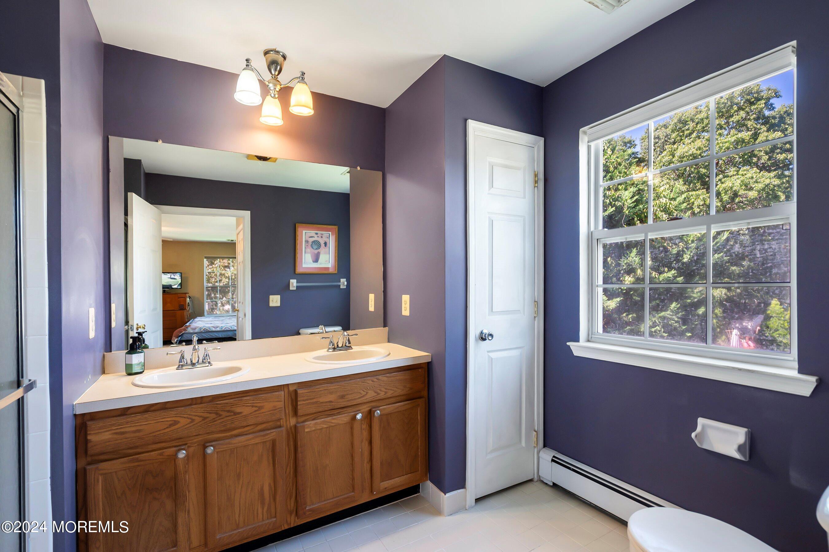 17 Glacier Drive Howell, NJ 07731 - Photo 21 of 43 a bathroom with a double vanity sink and a mirror