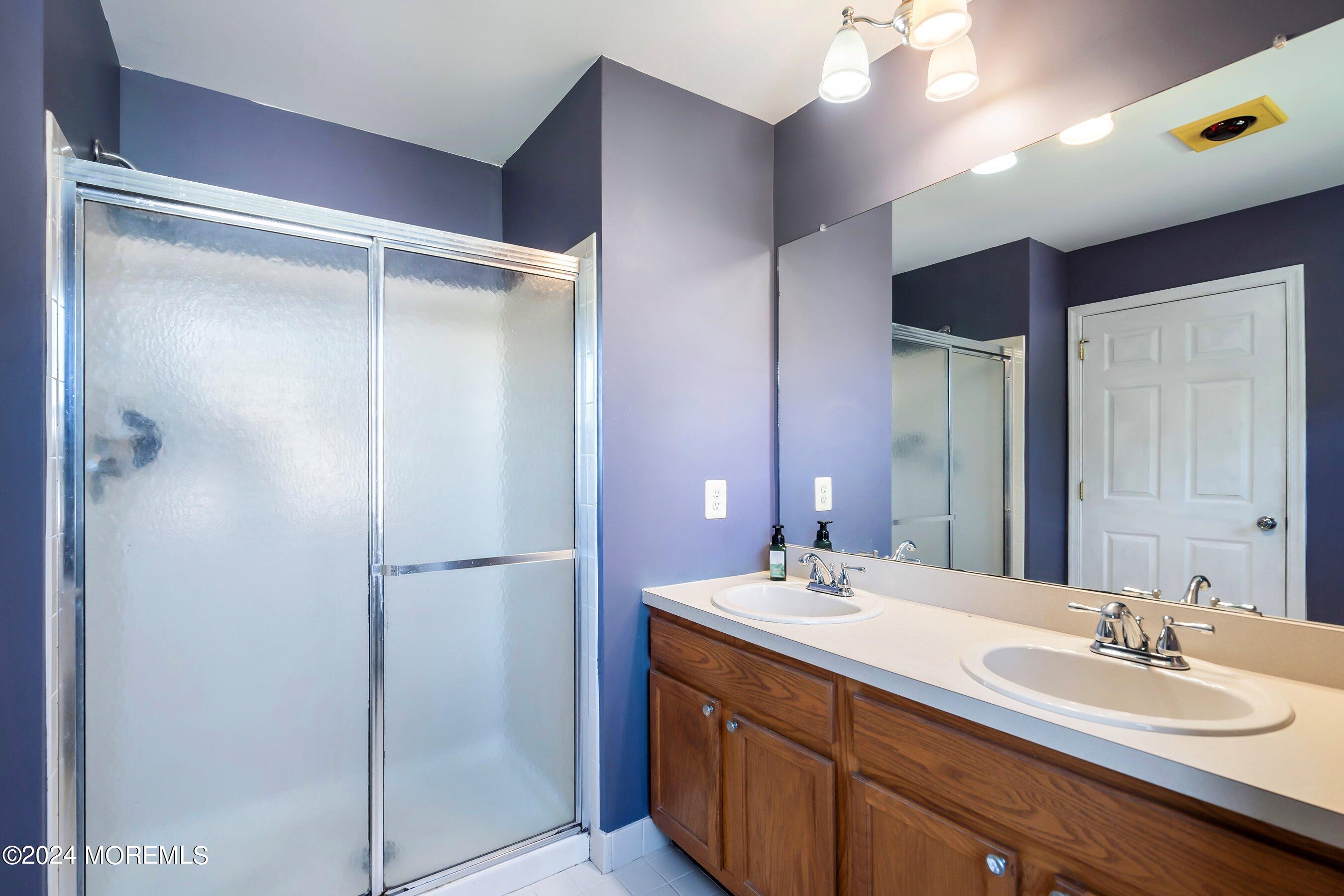 17 Glacier Drive Howell, NJ 07731 - Photo 22 of 43 a bathroom with a double vanity sink mirror and shower