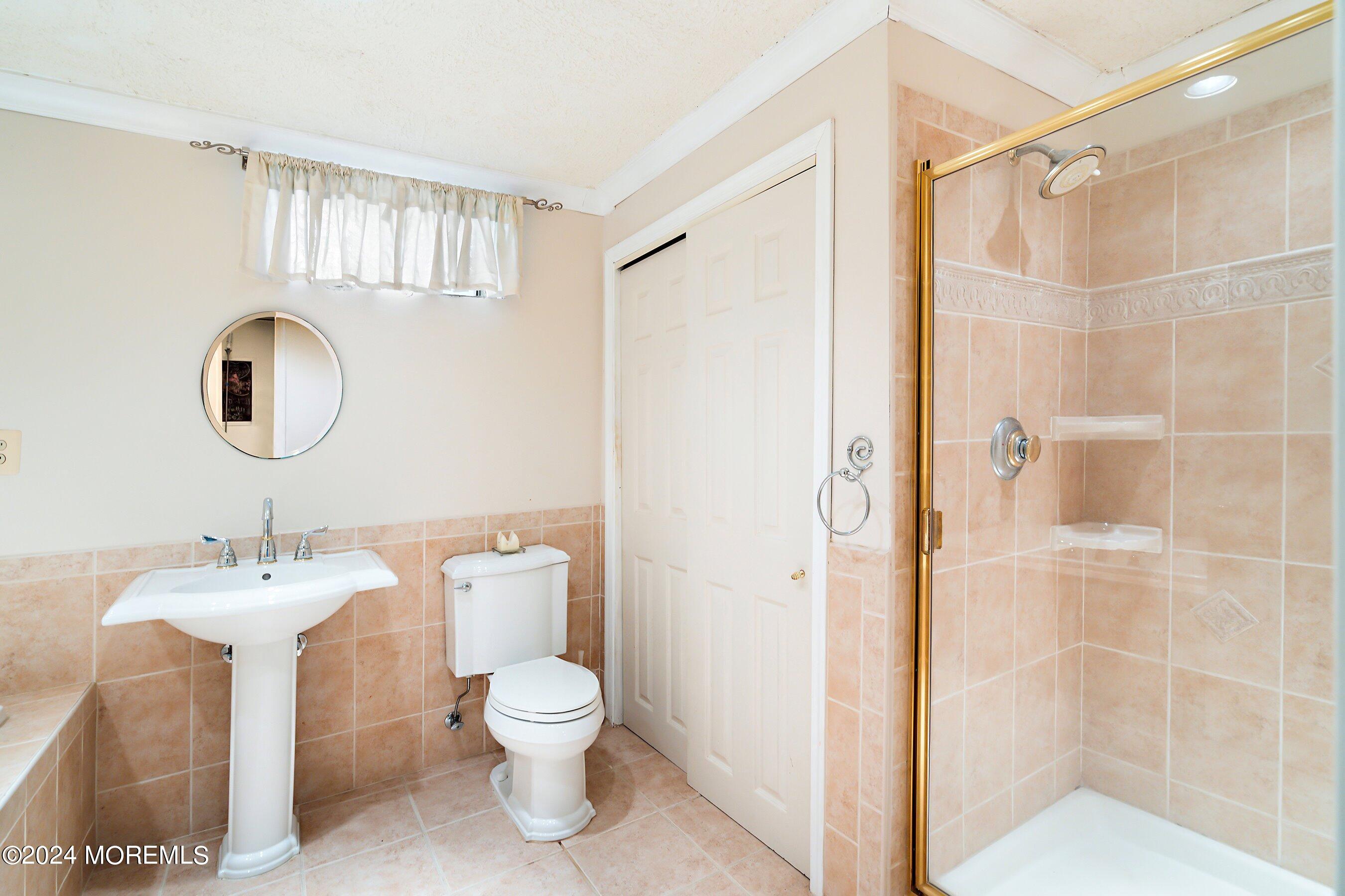 17 Glacier Drive Howell, NJ 07731 - Photo 26 of 43 a bathroom with a toilet sink and shower