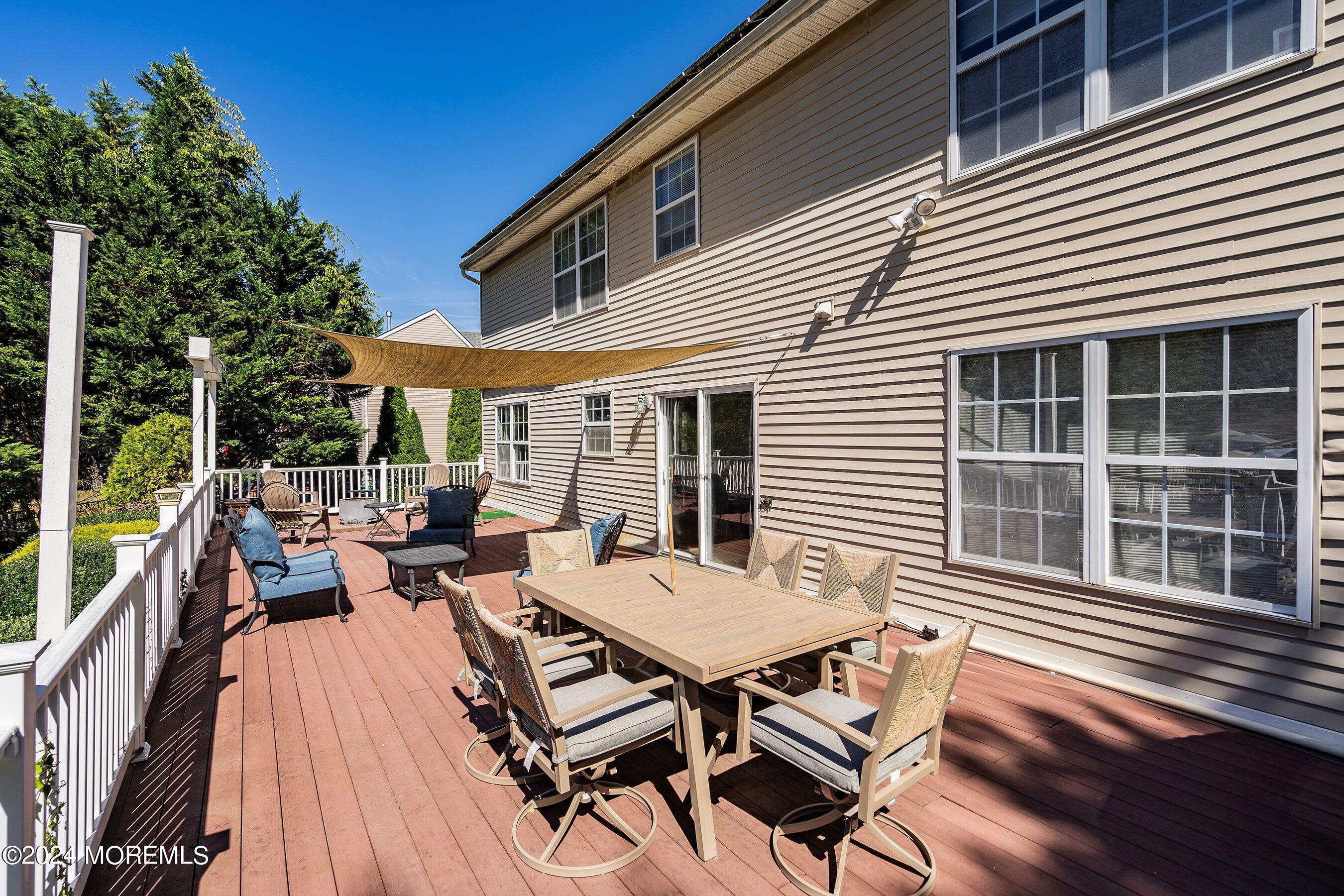 17 Glacier Drive Howell, NJ 07731 - Photo 31 of 43 a view of a patio with table and chairs and wooden floor