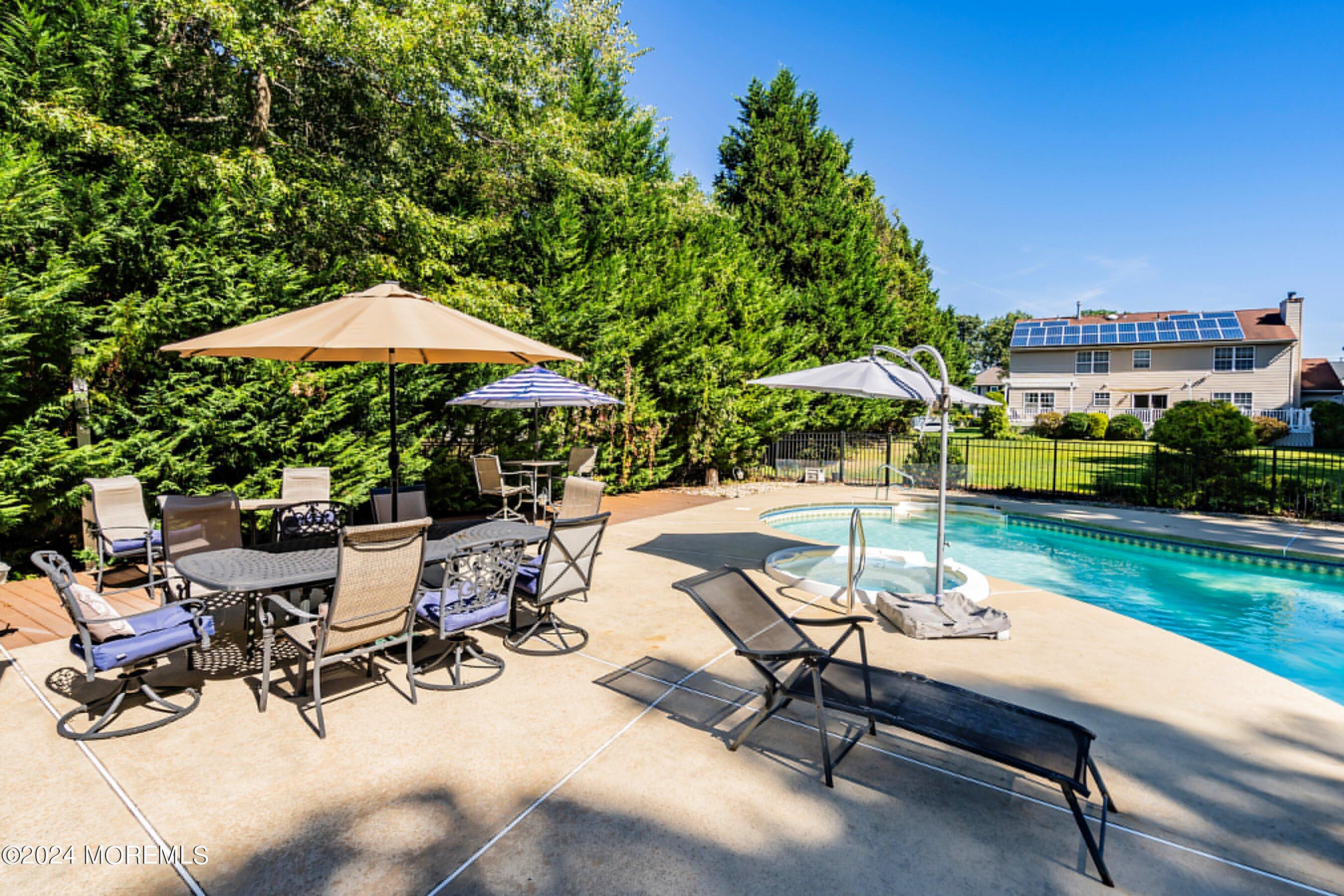 17 Glacier Drive Howell, NJ 07731 - Photo 35 of 43 a view of backyard with swimming pool and sitting area
