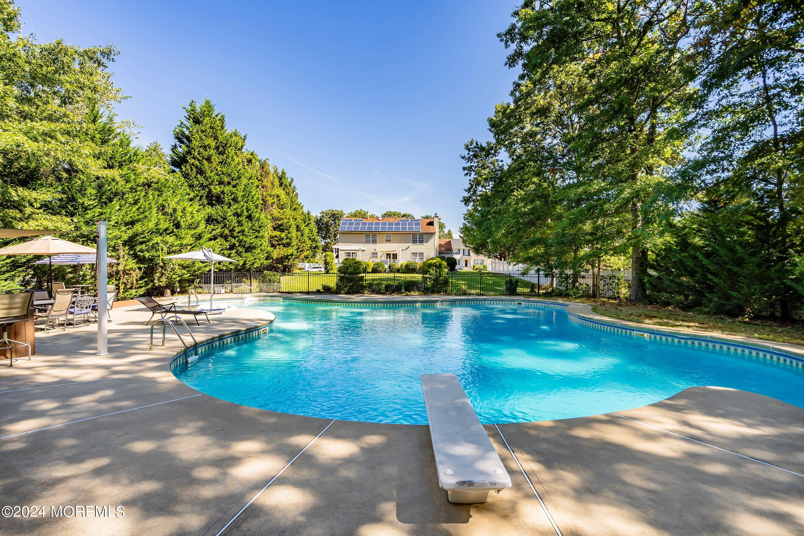 17 Glacier Drive Howell, NJ 07731 - Photo 36 of 43 a view of a swimming pool with a yard