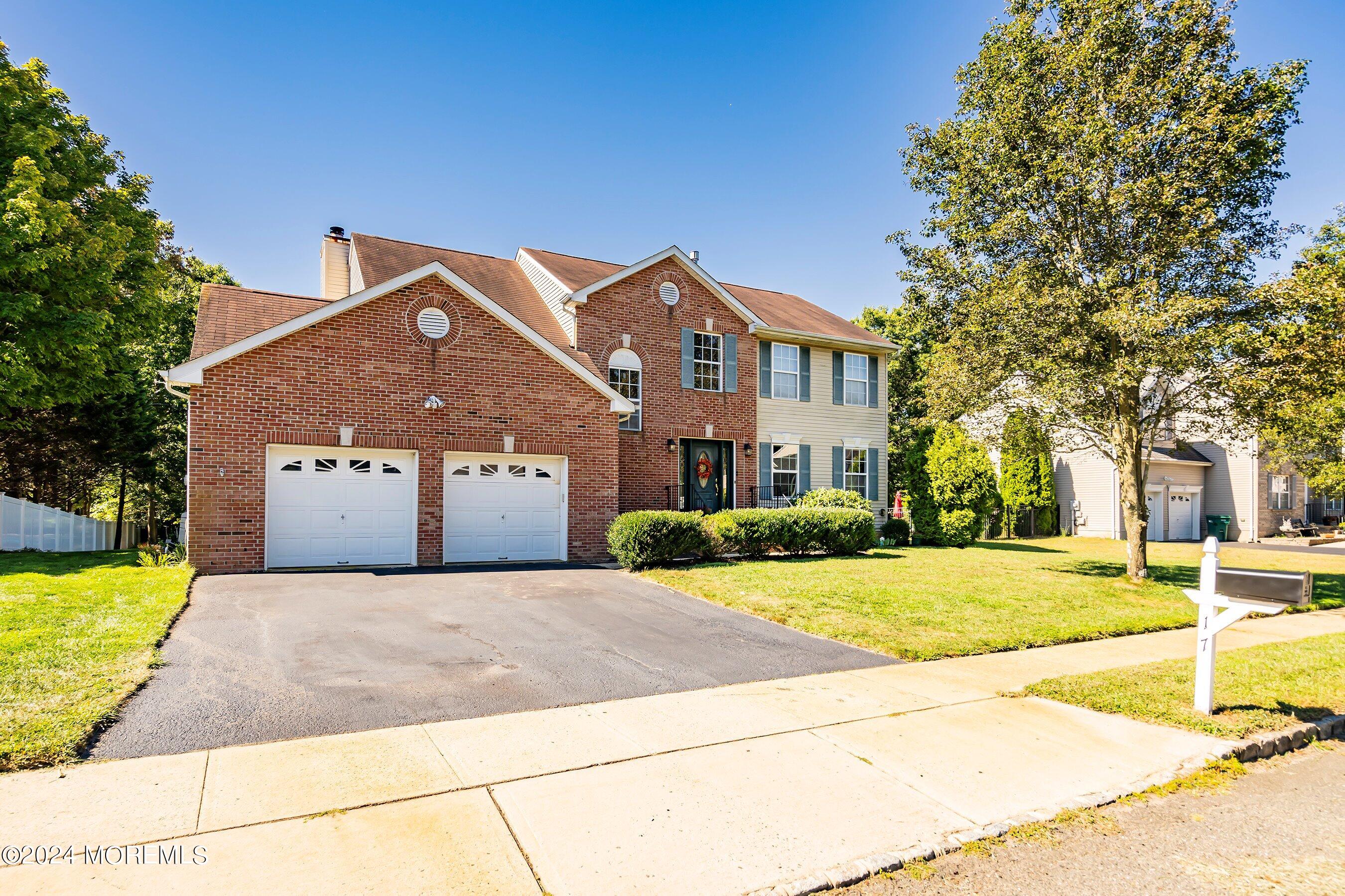 17 Glacier Drive Howell, NJ 07731 - Photo 5 of 43 a front view of a house with a yard and garage