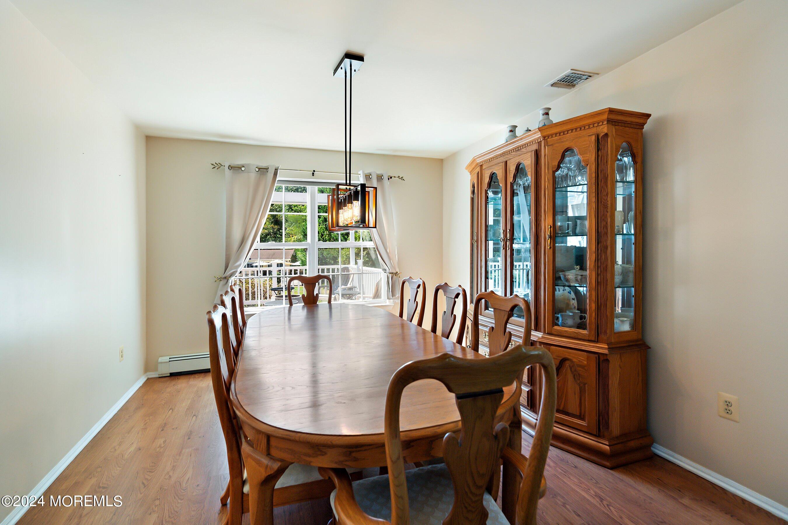 17 Glacier Drive Howell, NJ 07731 - Photo 8 of 43 a view of a dining room with furniture window and wooden floor