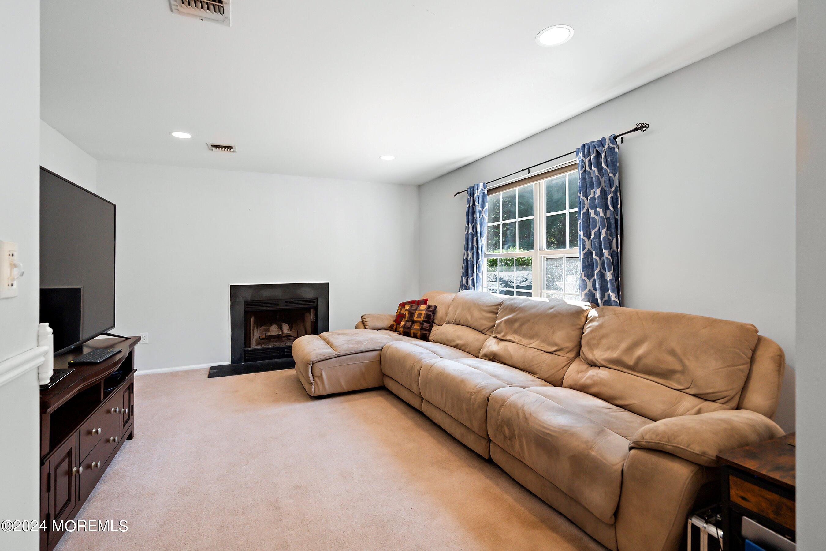 17 Glacier Drive Howell, NJ 07731 - Photo 9 of 43 a living room with furniture and a flat screen tv