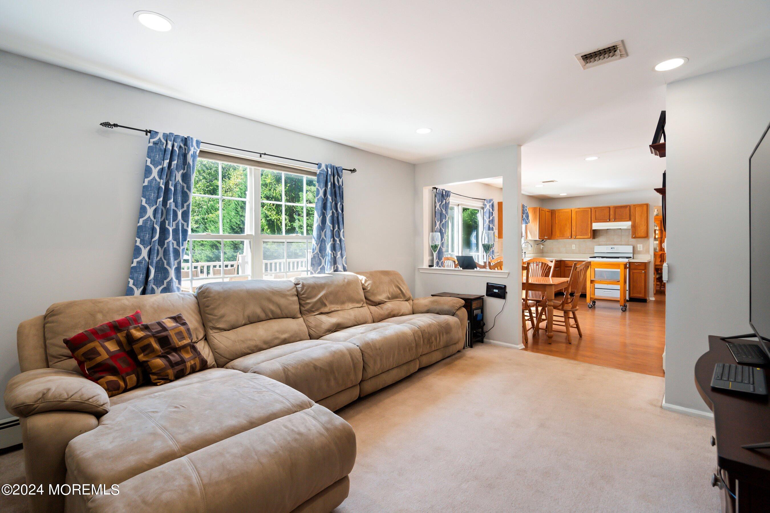 17 Glacier Drive Howell, NJ 07731 - Photo 10 of 43 a living room with furniture and a large window