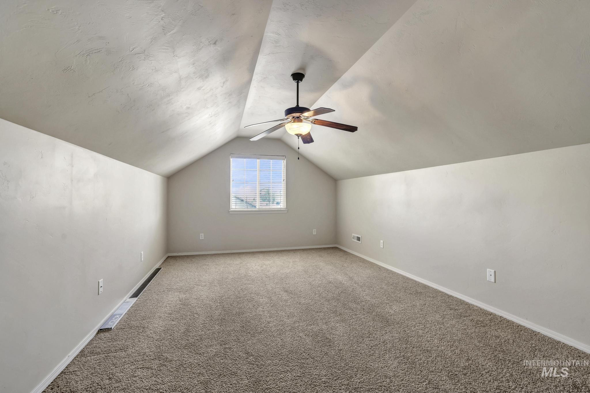 446 Noble Street Twin Falls, ID 83301 - Photo 22 of 42 Spacious room with sloped ceilings, recessed window, and neutral-toned carpeting