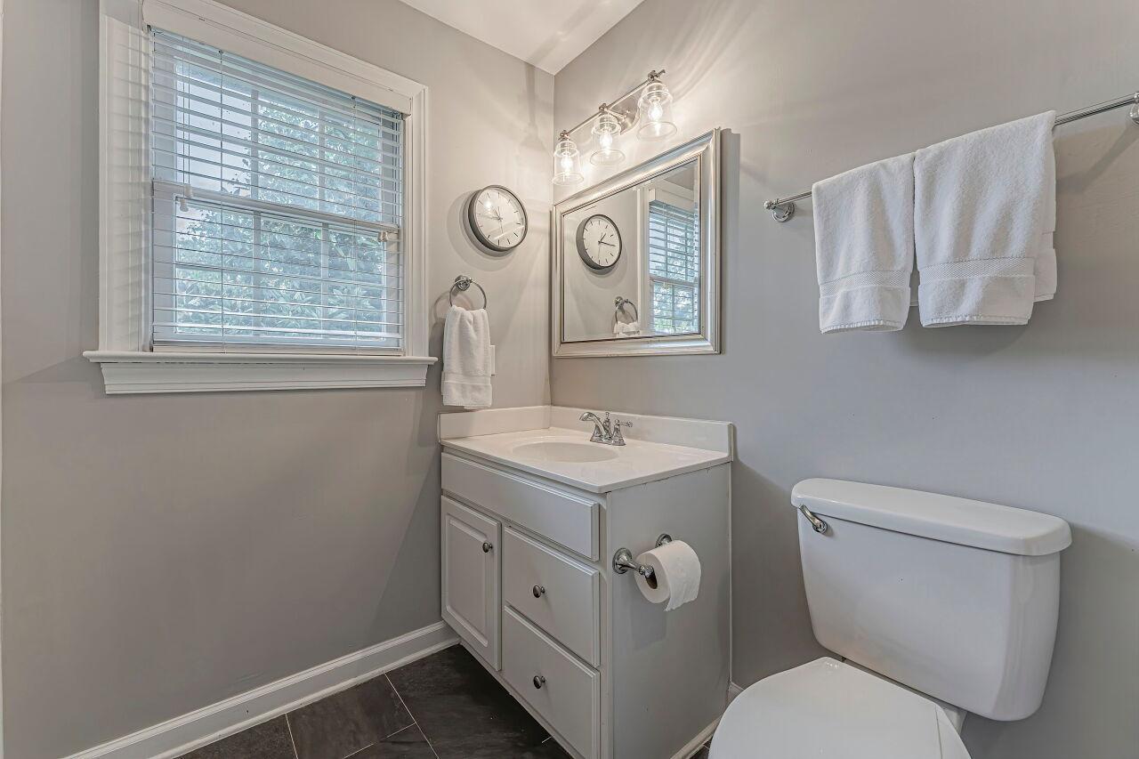 106 Hatfield Lane Raleigh, NC 27603 - Photo 21 of 29 a bathroom with a toilet sink and mirror